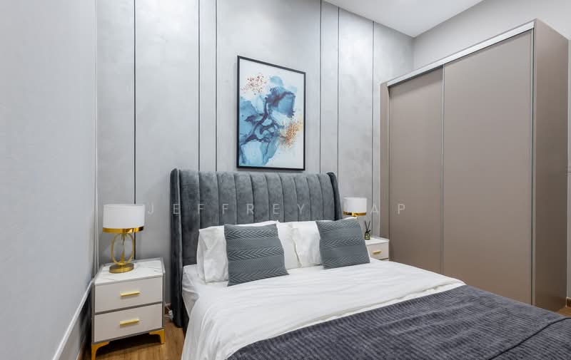 Bedroom features: king-size bed, upholstered headboard in grey, white bedding, decorative throw blanket in dark grey, two bedside tables with gold accents, table lamps with white shades and gold bases, framed artwork on wall with blue and gold tones, built-in wardrobe with sliding doors in beige, wooden flooring, grey accent wall with paneling; style: modern.