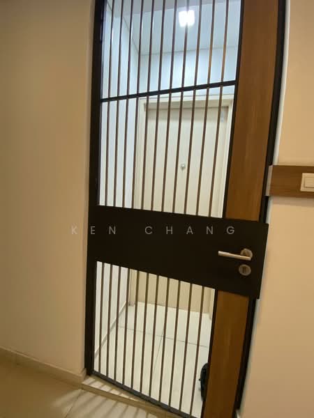 Room features: metal security door with vertical bars, wooden door frame, light fixture on ceiling, neutral wall color, tile flooring; style: modern.