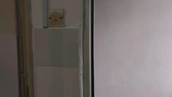 Room features: white painted walls, grey wall section, electrical outlet, metallic surface, unknown flooring.