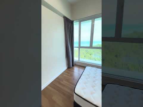 Bedroom features: large floor-to-ceiling windows, grey curtains, wooden flooring, unmade bed with mattress, white painted walls, view of greenery, natural light, minimalist decor; style: modern; view: garden.