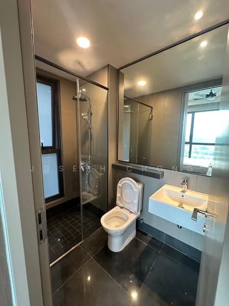 Bathroom features: glass shower enclosure, rain shower head, handheld shower, white wall-mounted sink, chrome basin mixer faucet, one-piece toilet, black tile flooring, grey wall tiles, large mirror, recessed lighting; style: modern.