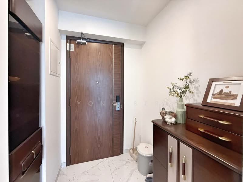 Room features: wooden door with peephole, white painted walls, marble tile flooring, console table with drawers, decorative vase with flowers, framed artwork, wall-mounted light fixture, toilet bowl visible; style: modern.