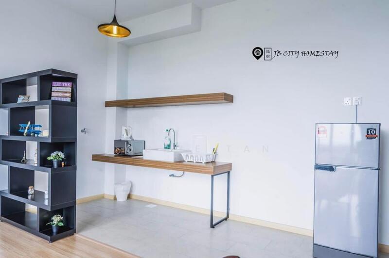 Room features: light wood flooring, white painted walls, shelf with wooden countertop, stainless-steel sink, chrome pull-down faucet, microwave, fridge, decorative plants on shelf, pendant light fixture; style: modern.