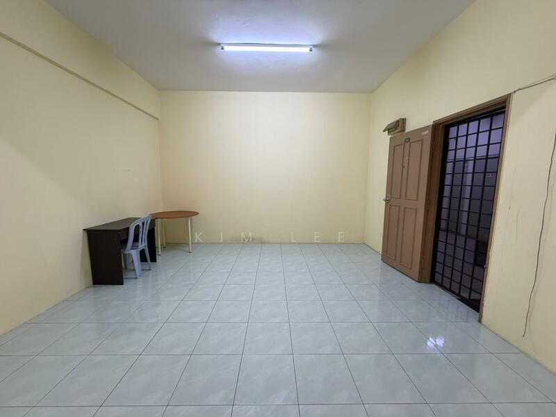 Room features: light grey tiled flooring, cream painted walls, fluorescent ceiling light, wooden door, glass panel door, table, plastic chairs; style: minimalist.