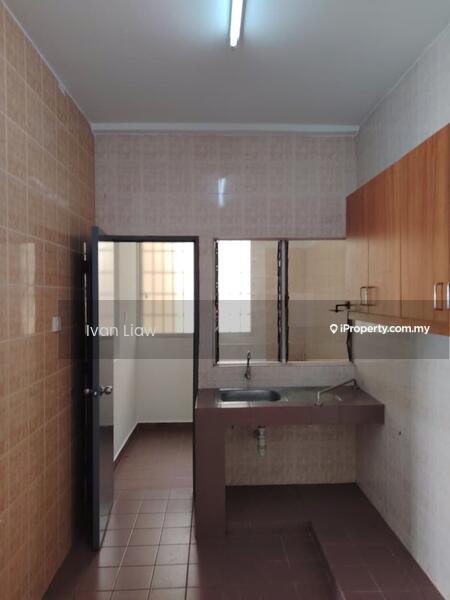 Kitchen features: brown laminate cabinetry, grey countertop, single-bowl stainless-steel sink, chrome faucet, wall-mounted mirror, cream tiled walls, brown tiled flooring, fluorescent ceiling light.