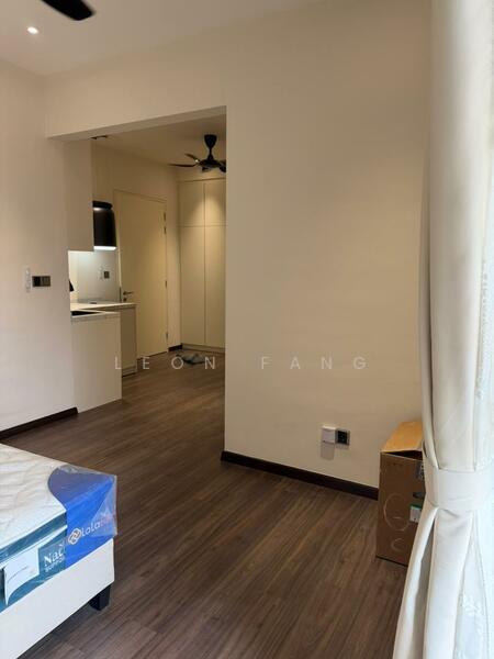 Room features: wooden flooring, white painted walls, ceiling fan, window with curtain, doorway leading to kitchen, box in corner; style: modern.