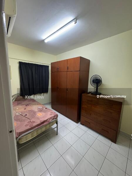 Bedroom features: single bed with patterned bedspread, wooden wardrobe, wooden dresser, ceiling light fixture, wall-mounted air conditioning unit, tiled flooring, blackout curtains, fan.