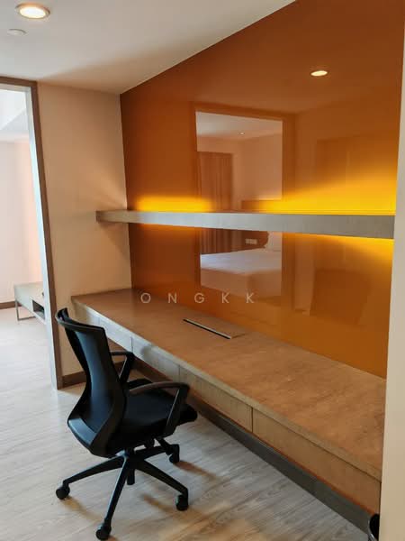 Study features: built-in desk with concrete surface, orange accent wall, wall-mounted shelf, task chair, laminate flooring, recessed lighting, neutral wall color, minimalist design; style: modern.