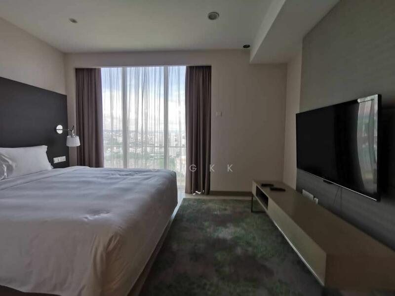 Bedroom features: king-size bed with white bedding, floor-to-ceiling windows, curtains, wall-mounted TV, TV console, carpet flooring in green, accent wall in dark color, recessed ceiling lights, side table with lamp; style: modern; view: city.