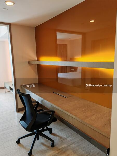 Study features: wooden desk with built-in storage, black ergonomic office chair, orange accent wall, light wood flooring, shelf above desk, recessed lighting, neutral wall color, window with natural light; style: modern.