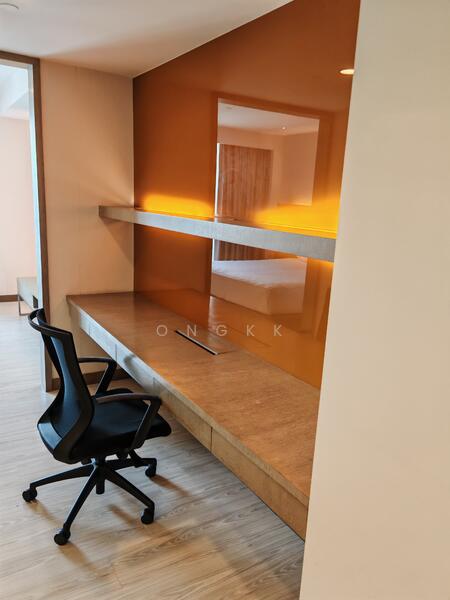 Study features: built-in desk with wood finish, orange accent wall, shelf above desk, black ergonomic office chair, laminate flooring, recessed lighting, neutral wall color, minimalist design; style: modern.