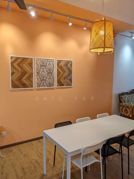 Dining features: orange painted walls, wooden flooring, white rectangular dining table, black and white dining chairs, three framed artworks on wall, pendant light fixture, track lighting, decorative wall with patterned design; style: modern.