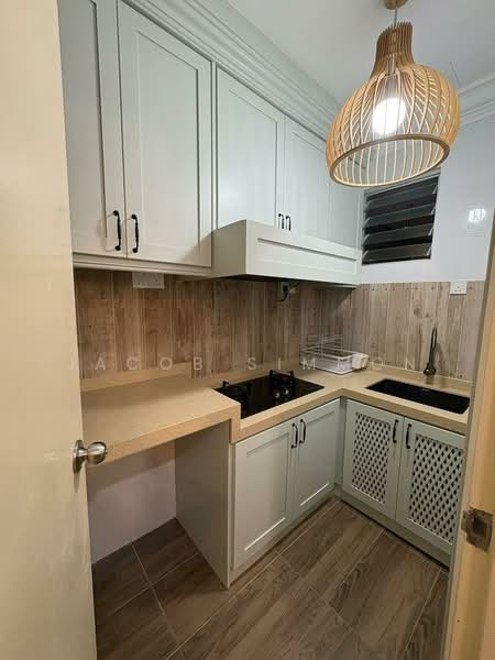 Kitchen features: light green cabinetry, white countertop, black sink, 2-burner gas hob, wood panel accent wall, tile flooring, hanging pendant light, window with horizontal slats, open shelving, decorative lattice cabinet doors; style: modern.