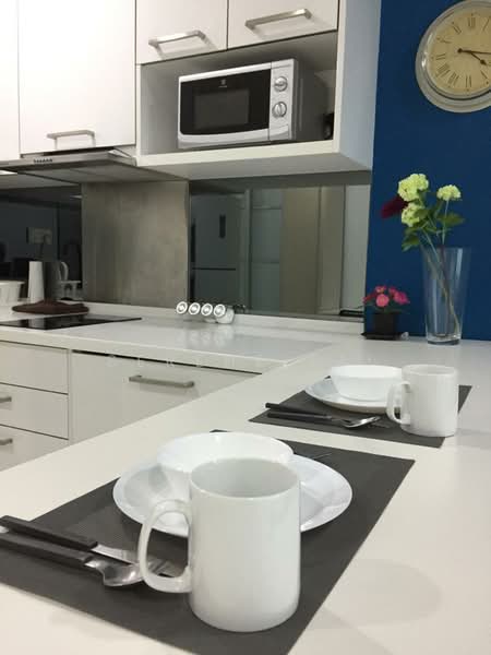 Kitchen features: white cabinetry, stainless-steel countertop, built-in microwave, kitchen island, ceramic cooktop, white plates, white mugs, cutlery, grey placemats, decorative vase with flowers, wall clock, blue accent wall; style: modern.