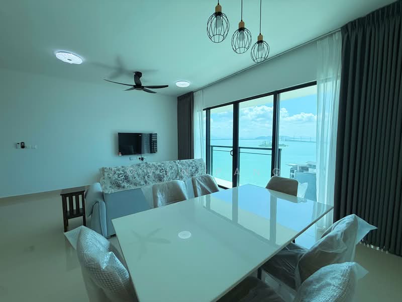 Dining features: white dining table, upholstered dining chairs, 3-blade ceiling fan, floor-to-ceiling windows, curtains, sofa with floral pattern, wall-mounted TV, light fixtures with pendant lamps, sea view; style: modern; view: sea.
