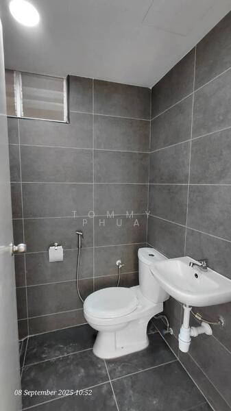 Bathroom features: grey tiled walls, dark grey tiled flooring, white toilet, white sink, chrome basin mixer faucet, wall-mounted bidet spray, mirror above sink, window for natural light; style: modern.