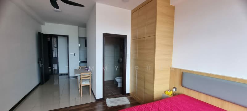 Bedroom features: wooden flooring, white painted walls, queen-size bed with pink bedding, upholstered headboard, built-in wardrobe with wooden finish, ceiling fan, window with natural light, decorative bedside lamp, study desk with chair; style: modern. Bathroom features: one-piece toilet, white tiled walls, grey tiled flooring, shower area, mirror above sink. Kitchen features: open kitchen layout, white cabinetry, stainless-steel sink, built-in stove, refrigerator, countertop space.