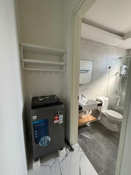Laundry features: front-load washing machine, white walls, grey tile flooring, mirror above sink, wall-mounted shelf, shower with glass enclosure, toilet, sink with wooden shelf; style: modern.