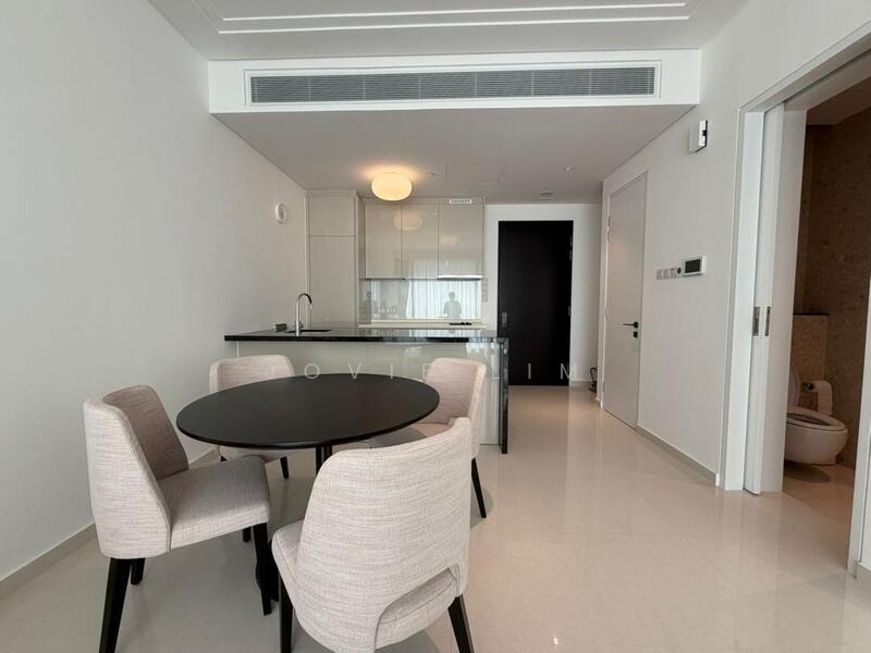 Dining features: round black dining table, 4 upholstered dining chairs in light fabric, white painted walls, marble tile flooring, recessed downlights, kitchen island with sink, glass backsplash, open layout to living area; style: modern. Room features: white painted walls, marble tile flooring, recessed downlights, doorway to bathroom.