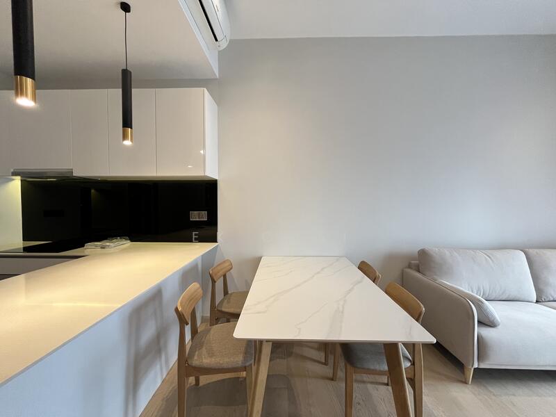 Dining features: white marble dining table, 4 wooden dining chairs with fabric seats, pendant light fixture, open kitchen layout, light wood flooring, white cabinetry, black backsplash, recessed lighting, air conditioning unit; style: modern. Living features: light grey fabric sofa, neutral wall color, wood flooring; style: modern.
