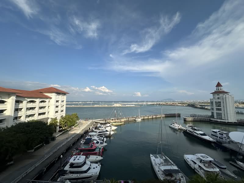 Exterior type: low-rise apartment block; features: waterfront view, marina with boats, surrounding greenery, lighthouse structure, blue sky with clouds, paved walkway along the water; style: modern.