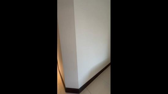 Room features: white painted walls, brown skirting, tile flooring.