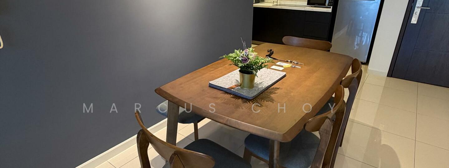 Dining features: wooden dining table, 6-seater dining table, upholstered dining chairs, decorative centerpiece with plant, grey accent wall, tile flooring, kitchen visible in background, refrigerator visible in background; style: modern.