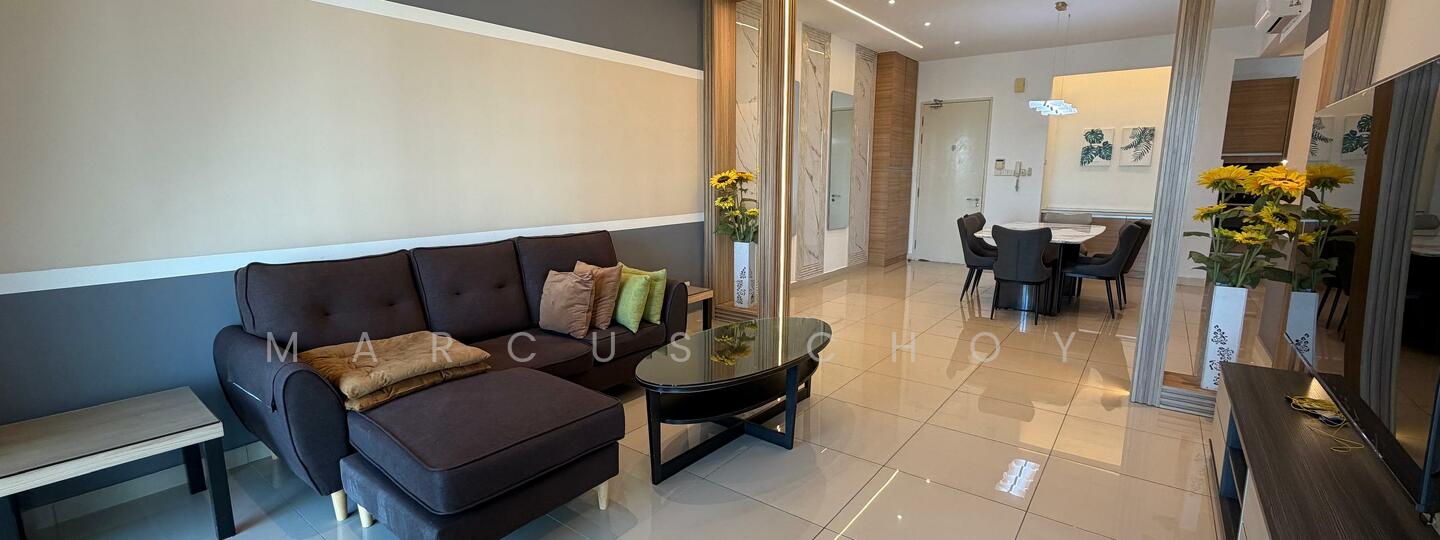 Living features: 3-seater fabric sofa in dark brown, decorative cushions in various colors, glass coffee table, wall-mounted TV, TV console in dark wood, cream painted walls, grey accent wall, recessed downlights, large floor tiles in glossy finish, decorative wall art, potted sunflowers, dining area visible in background; style: modern.