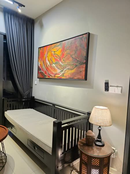 Room features: grey painted walls, artwork with abstract design in warm colors, black wooden daybed with storage drawers, table lamp with beige shade, decorative side table with intricate design, floor-to-ceiling curtains in dark grey, light-colored flooring, wall-mounted intercom or control panel; style: modern.