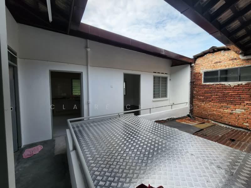 Room features: white painted walls, metal railing, roof with tiles, exposed brick wall, concrete flooring, sliding windows, outdoor terrace, partially covered area.