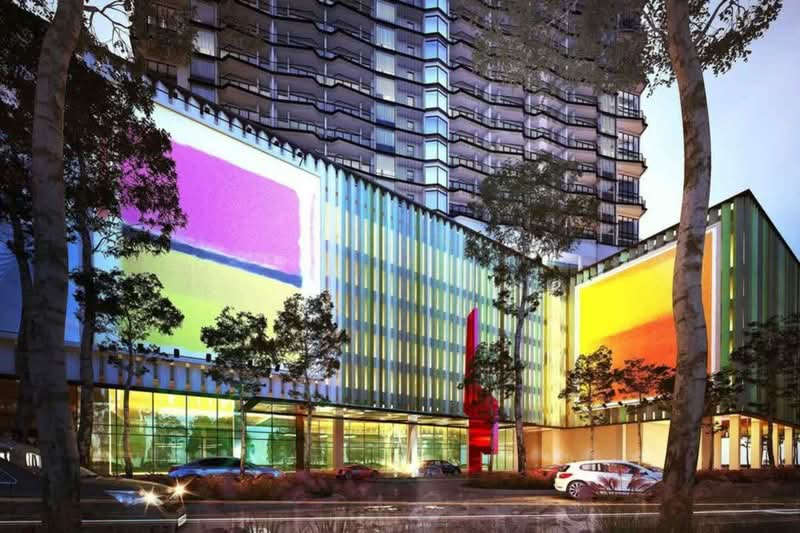 Exterior type: high-rise condominium; features: glass curtain wall, colorful facade with large panels, multiple storeys, surrounded by trees, street-level parking, art installation in front, modern architectural design; style: contemporary.