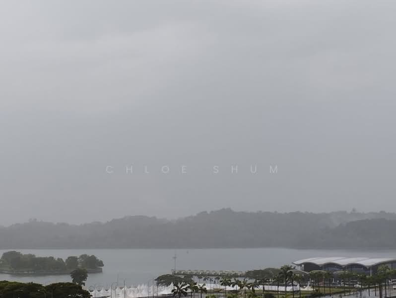 Exterior features: waterfront view, overcast sky, distant hills, landscaped greenery in foreground, modern architectural structure in foreground.