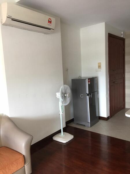 Room features: wall-mounted split AC, standing fan, fridge, brown wooden flooring, white painted walls, wooden door, light switch, corner table.