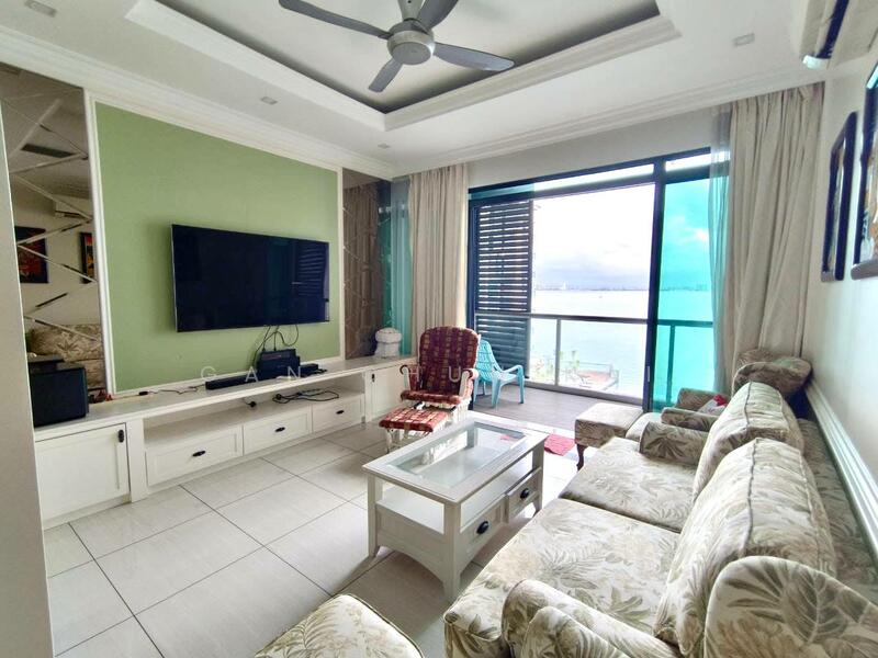 Living features: sofa with floral pattern, coffee table, wall-mounted TV, TV console with storage, ceiling fan, large windows with sea view, light-colored tiled flooring, recessed ceiling with crown moulding, sheer curtains, decorative armchair; style: modern; view: sea.