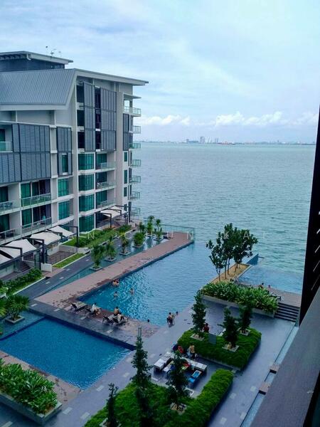 Exterior type: high-rise condominium; features: infinity pool, pool deck with loungers, landscaped garden with trees, waterfront view, glass curtain wall facade, balconies with glass railings, manicured lawn, outdoor seating area; style: modern.