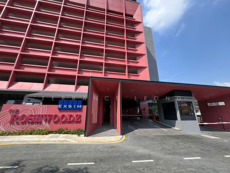 Exterior type: mid-rise condominium; features: red painted facade, covered entrance, landscaped garden, manicured lawn, driveway, parking area, signage with building name, multiple storeys, modern architectural design; style: modern.