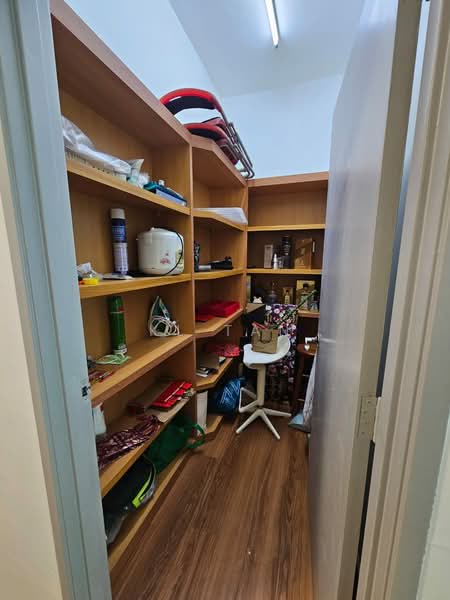 Room features: built-in shelving, wood laminate flooring, white walls, overhead fluorescent lighting, various storage items, plastic storage bins, cardboard boxes, small chair.