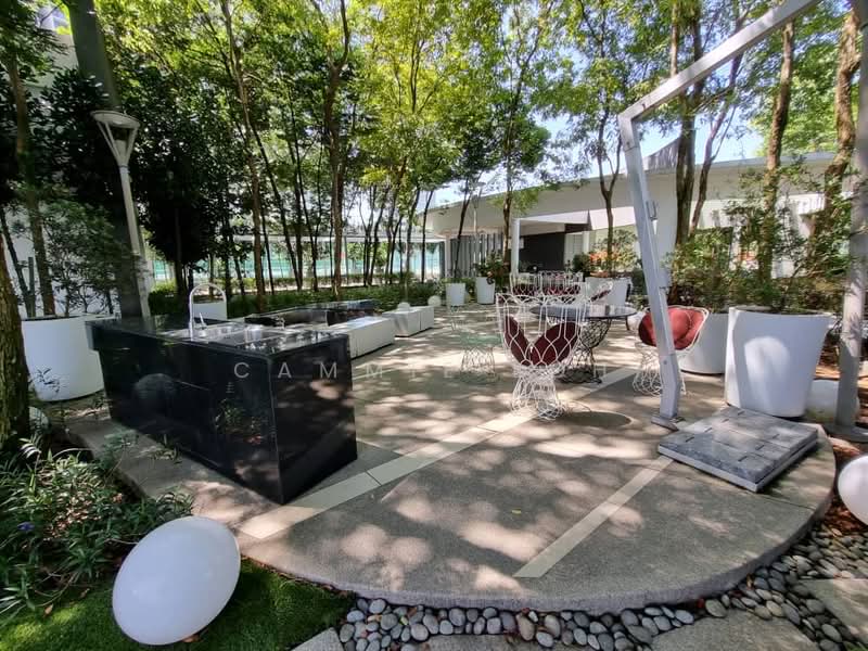Exterior type: landscape garden; features: outdoor kitchen with black countertop, stainless-steel grill, white modern outdoor seating, decorative stone pathway, manicured lawn, mature trees providing shade, white planters, ambient outdoor lighting, circular stone seating area, decorative pebbles; style: modern.