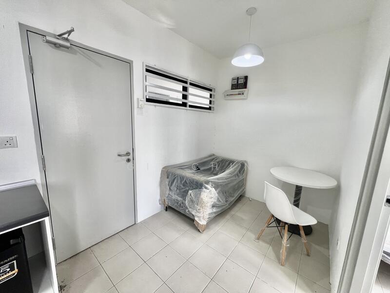 Room features: white painted walls, tile flooring, round dining table, white chair, air conditioning unit, light fixture, window with horizontal slats, plastic covering on furniture; style: minimalist.