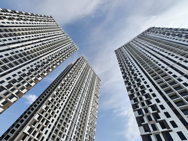 Exterior type: high-rise condominium; features: glass curtain wall, white painted facade, black accents, recessed balconies, vertical fins, approximately 20-storey high-rise; style: modern.