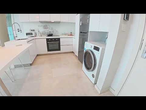 Kitchen features: white cabinetry, stainless-steel built-in oven, stainless-steel range hood, 4-burner gas hob, single-bowl stainless-steel sink, chrome pull-down faucet, white quartz countertop, ceramic tile backsplash, freestanding washing machine, refrigerator, pendant lighting, open shelving, neutral tile flooring; style: modern.