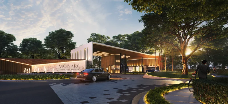 Exterior type: clubhouse; features: modern facade with wooden accents, water feature with fountains, landscaped garden with manicured lawns, paved driveway, outdoor lighting, large glass windows, covered entrance, surrounded by trees, signage with 'MONARC', multiple vehicle access points; style: modern.