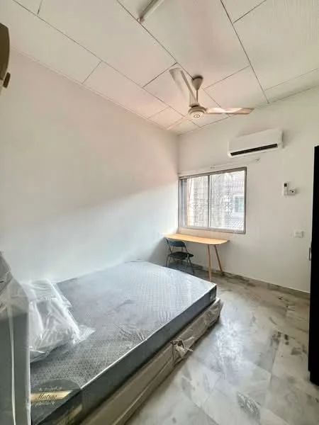 Bedroom features: single bed with mattress, ceiling fan, wall-mounted split AC, window with view, light-colored painted walls, marble flooring, study desk, chair; style: modern.