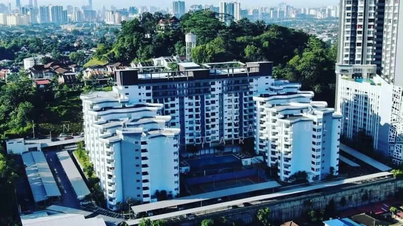 Exterior type: mid-rise condominium; features: white painted facade, recessed balconies, flat roof, approximately 5-storey, surrounded by mature greenery, tennis court visible, landscaped garden area, open-air parking lot, guard house at entrance, CCTV cameras visible; style: modern.