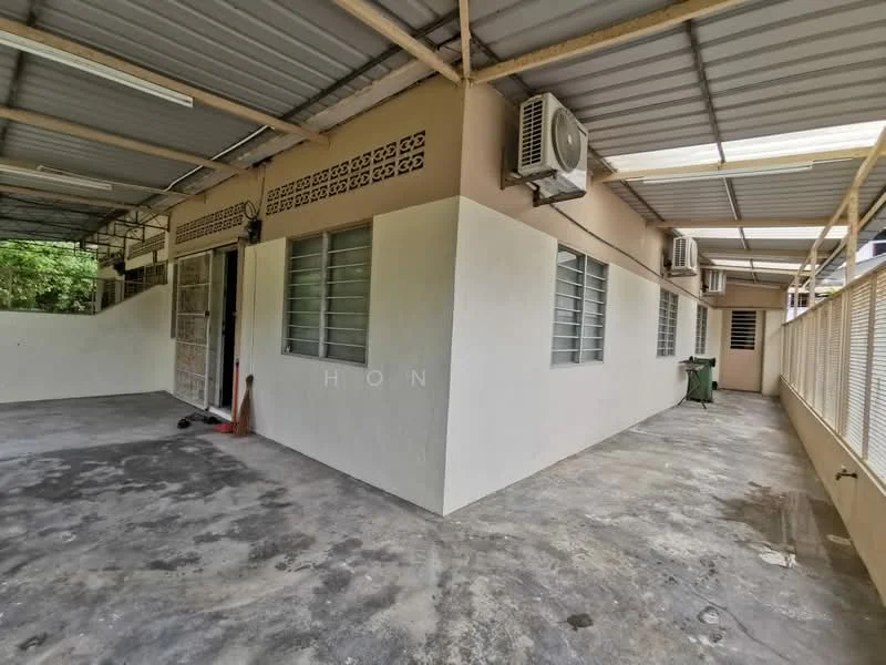 Exterior features: exposed concrete flooring, cream painted walls, metal roof, 2 wall-mounted split AC units, windows with metal grilles, open-air space, surrounded by greenery; style: modern.
