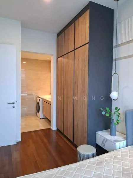 Bedroom features: wooden flooring, built-in wardrobe with wood finish, white walls, recessed lighting, ceiling light fixture, laundry area visible through doorway, decorative plant on bedside table, small round stool; style: modern.