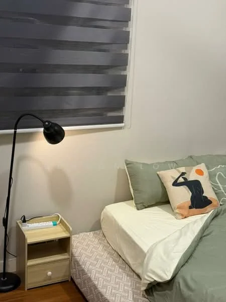 Bedroom features: single bed with white bedding, green throw blanket, decorative pillow with abstract design, wooden bedside table, black floor lamp, striped roller blinds, wooden flooring, wall-mounted artwork; style: modern.