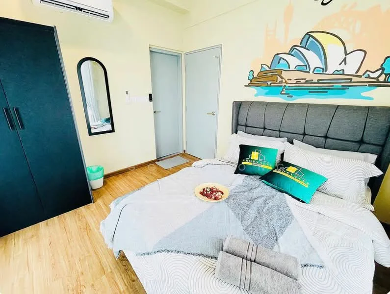 Bedroom features: queen-size bed with grey upholstered headboard, decorative pillows in green and white, light wood laminate flooring, wall-mounted air conditioning unit, painted accent wall with Sydney Opera House mural, black wardrobe with sliding doors, full-length mirror, door leading to hallway, small green waste bin, bedside table with decorative items, platter with fruits on bed; style: modern.
