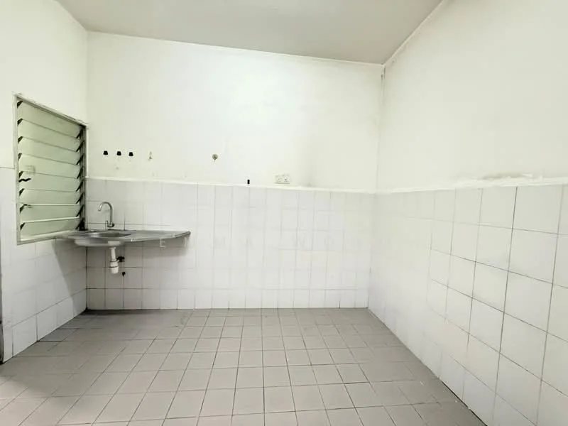 Room features: white tiled walls, grey tiled flooring, single-bowl stainless-steel sink, metal faucet, window with horizontal slats, empty space, no visible cabinetry, no visible appliances.