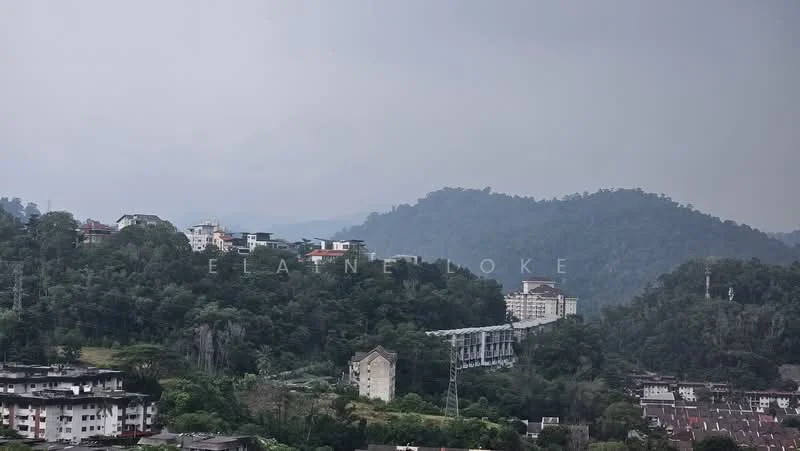 Exterior features: hilly terrain, residential buildings on hillside, dense greenery, cloudy sky, mountain backdrop.